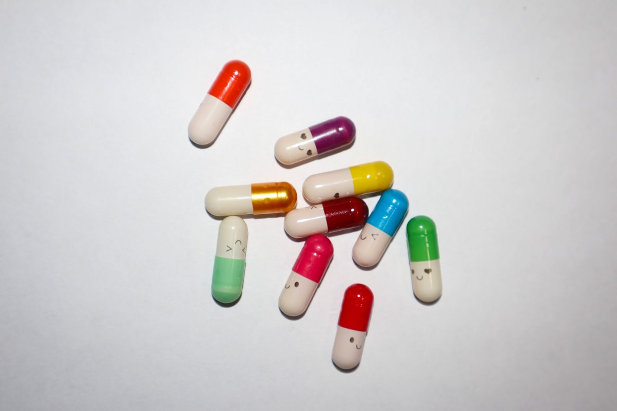 Natural supplements for men's health displayed on a wooden table with green plants